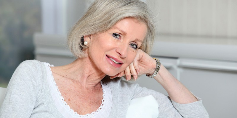 Closeup of smiling senior woman relaxing at home